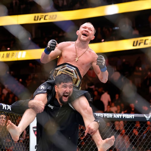 Petr Yan celebrates with a member of his team after defeating UFC bantamweight champion Merab Dvalishvili during UFC 323 Saturday, Dec. 6, 2025, in Las Vegas. (Steve Marcus/Las Vegas Sun via AP)