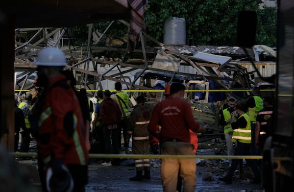 Civil defence workers inspect the area following an Israeli airstrike on Dahiyeh in the southern suburb of Beirut, Lebanon, Sunday, April 27, 2025. (AP Photo/Bilal Hussein)