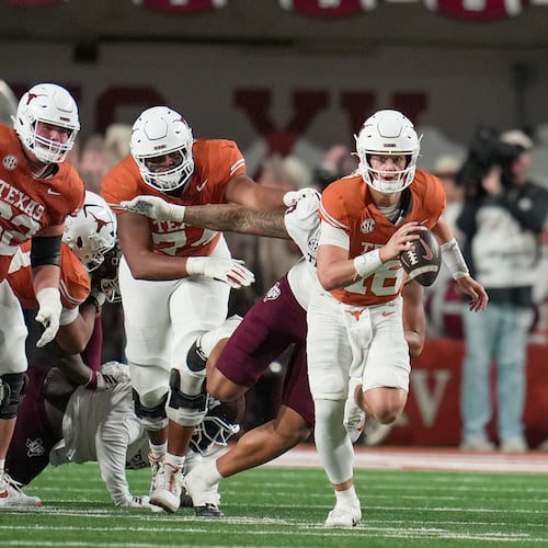 Texas quarterback Arch Manning (16) looks for room to run against Texas A&M defense during the first half of an NCAA college football game in the Lone Star Showdown in Austin, Texas, Friday, Nov. 28, 2025. (Ricardo B. Brazziell/Austin American-Statesman via AP)