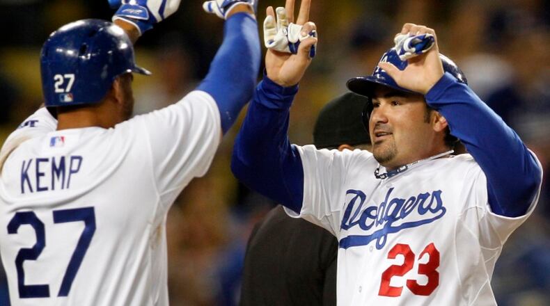 The Los Angeles Dodgers' Matt Kemp (27) congratulates Adrian Gonzalez at home plate after Gonzalez hit a home run against the Colorado Rockies at Dodger Stadium in Los Angeles on September 27, 2013. (Allen J. Schaben/Los Angeles Times/TNS)