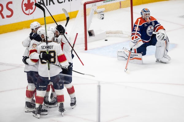 Florida Panthers players, left, celebrate after a goal as Edmonton Oilers' goalie Calvin Pickard (30) looks on during the first period in Game 5 of the NHL hockey Stanley Cup Final in Edmonton, Alberta, Saturday, June 14, 2025. (Jason Franson/The Canadian Press via AP)