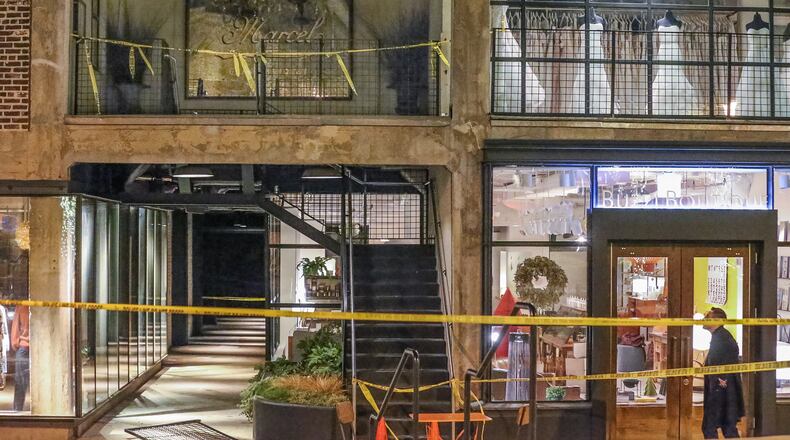 Two men were injured Wednesday night when a railing collapsed in Midtown. JOHN SPINK / JSPINK@AJC.COM