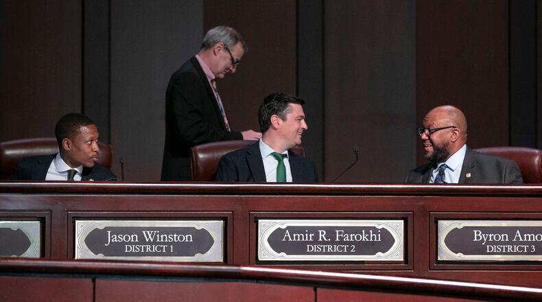 Council members Jason Winston (from left), Howard Shook, Amir R. Farokhi and Byron Amos confer as the Atlanta City Council held their first in person meeting since they were suspended at start of the pandemic In Atlanta on Monday, March 21, 2022.   (Bob Andres / robert.andres@ajc.com)