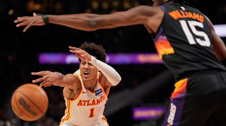 Atlanta Hawks forward Jalen Johnson (1) passes against Phoenix Suns center Mark Williams (15) during the first half of an NBA basketball game, Friday, Jan. 23, 2026, in Atlanta. (AP Photo/Mike Stewart)