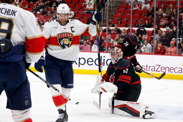 Florida Panthers' Aleksander Barkov, right, celebrates his goal with Florida Panthers' Matthew Tkachuk (19) as Carolina Hurricanes goaltender Pyotr Kochetkov (52) looks on during the third period of Game 2 of the NHL hockey Stanley Cup Eastern Conference finals in Raleigh, N.C., Thursday, May 22, 2025. (AP Photo/Karl DeBlaker)