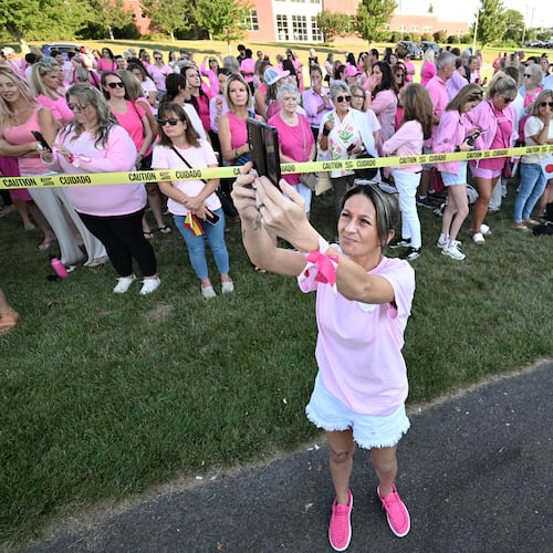 Aimee Breault of Acushnet, Mass., live-streams a demonstration in support of Lindsay Clancy outside Plymouth Superior Court, where Clancy is on trial in connection with the deaths of her three children, Thursday, Aug. 20, 2026, in Plymouth, Mass. (AP Photo/Josh Reynolds )