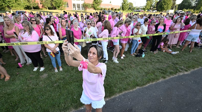 Aimee Breault of Acushnet, Mass., live-streams a demonstration in support of Lindsay Clancy outside Plymouth Superior Court, where Clancy is on trial in connection with the deaths of her three children, Thursday, Aug. 20, 2026, in Plymouth, Mass. (AP Photo/Josh Reynolds )