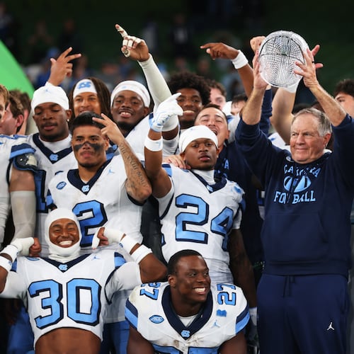 North Carolina head coach Bill Belichick, center right, and his team celebrate after defeating TCU in an NCAA college football game in Dublin, Ireland, Saturday, Aug. 29, 2026. (AP Photo/Peter Morrison)