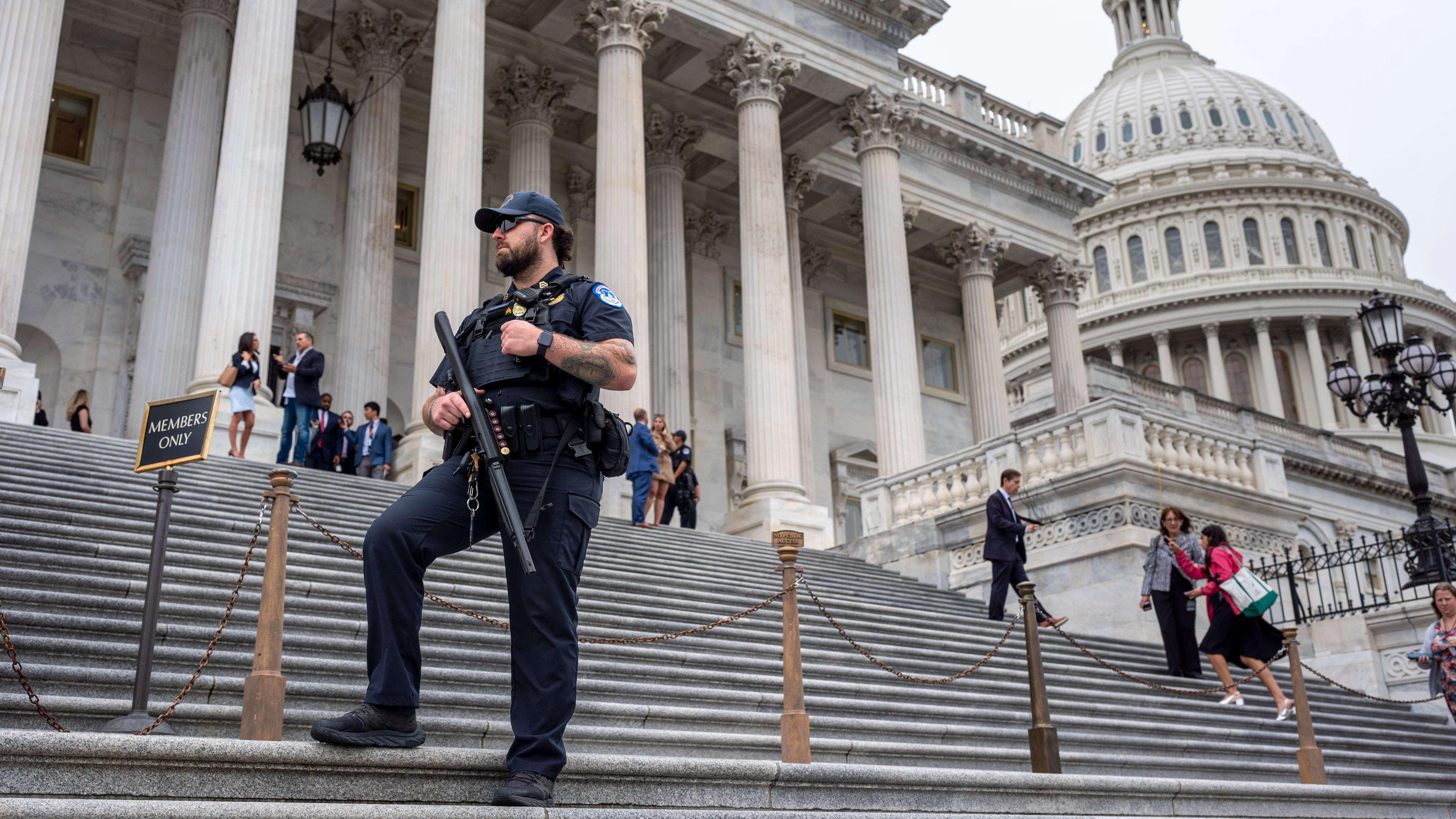FILE - A U.S. Capitol Police officer stands watch as lawmakers leave the House of Representatives after voting at the Capitol in Washington, Sept. 25, 2024. (AP Photo/J. Scott Applewhite, File)