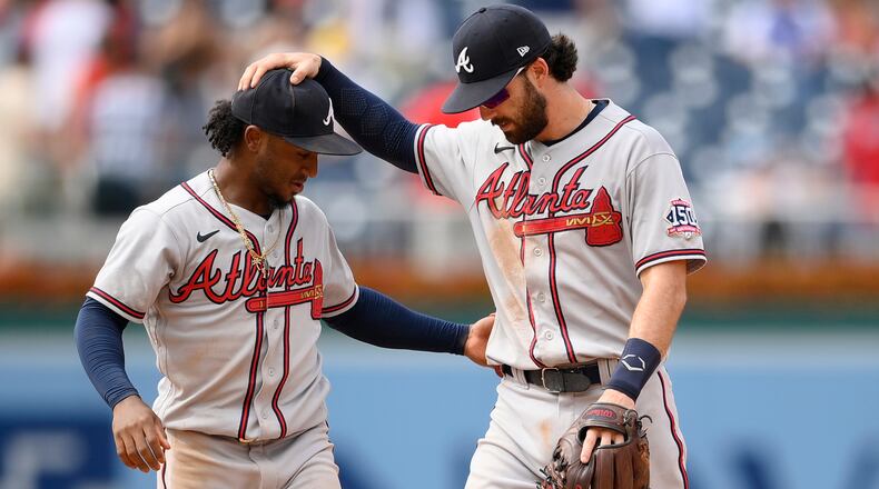 Braves second baseman Ozzie Albies (left) and shortstop Dansby Swanson celebrate 6-5 win over the Washington Nationals, Sunday, Aug. 15, 2021, in Washington. (Nick Wass/AP)