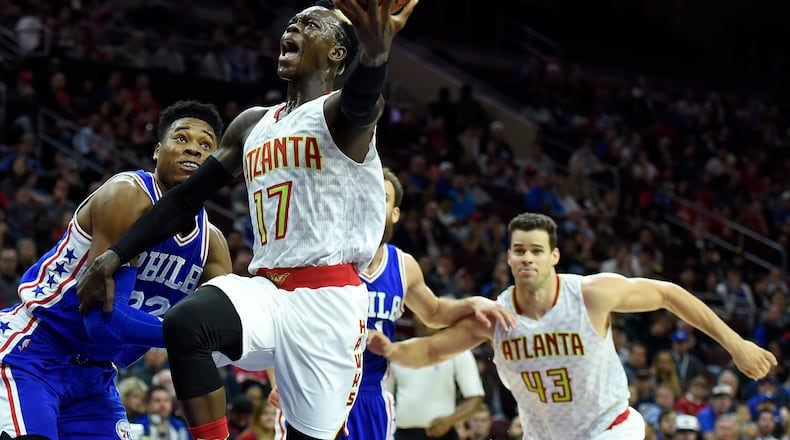 Atlanta Hawks’ Dennis Schroder (17) drives to the basket past Philadelphia 76ers’ Richaun Holmes (22) during the first half of an NBA basketball game, Saturday, Oct. 29, 2016, in Philadelphia. (AP Photo/Michael Perez)