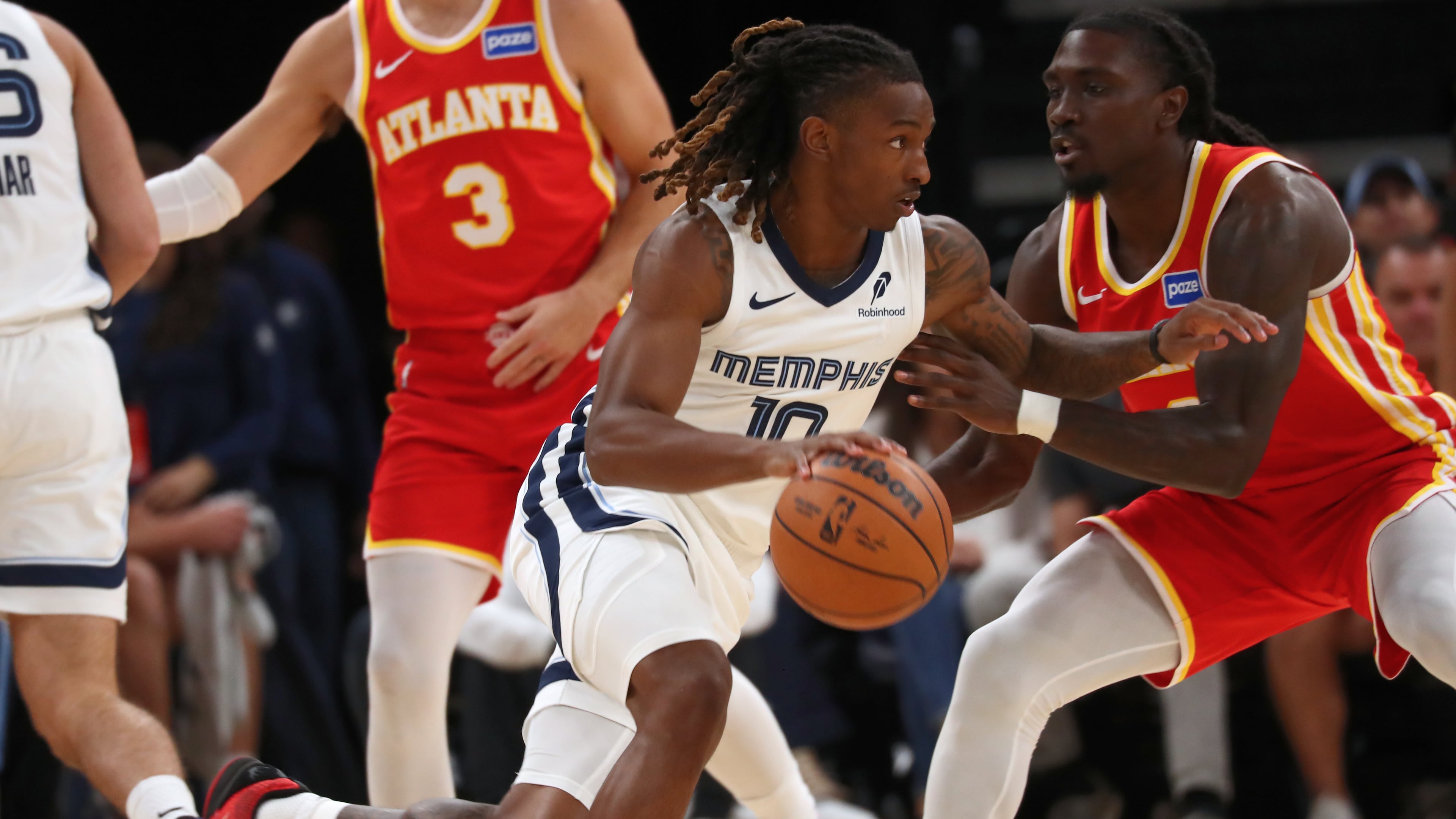 Grizzlies guard Javon Small (center) drives against Hawks guard Keaton Wallace (right) in the first half Saturday, Oct. 11, 2025, in Memphis, Tenn. Wallace had a solid all-around game with six points, seven assists, two rebounds and three steals. (Nikki Boertman/AP)