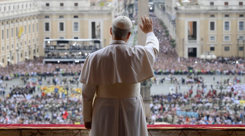 Pope Leo XIV waives from the central balcony of St. Peter's Basilica overlooking St. Peter's Square where tens of thousands of faithful gathered to receive the first traditional Sunday blessing after his election May 11, 2025. (Vatican Media via AP)