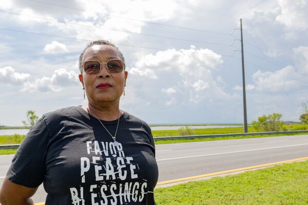 Semona Holmes stands in front of the marsh that is located near her home on Wednesday, July 17, 2024 in Brunswick, Georgia.  (Katelyn Myrick for The Atlanta Journal-Constitution))
