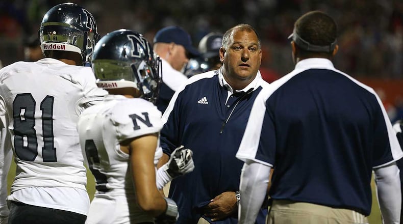 Norcross head coach Keith Maloof (center) talks with players and coaches in the fourth quarter of a victory over Parkview.