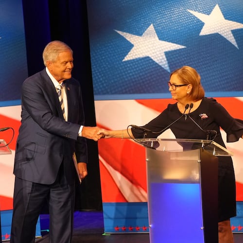U.S. Rep. Ralph Norman, R-S.C., left, reaches over to shake hands with Sen. Darline Graham, R-S.C., during a debate ahead of the special GOP Senate runoff election to replace the late Sen. Lindsey Graham, R-S.C., in Newberry, S.C., Tuesday, Aug. 18, 2026. (AP Photo/Meg Kinnard)