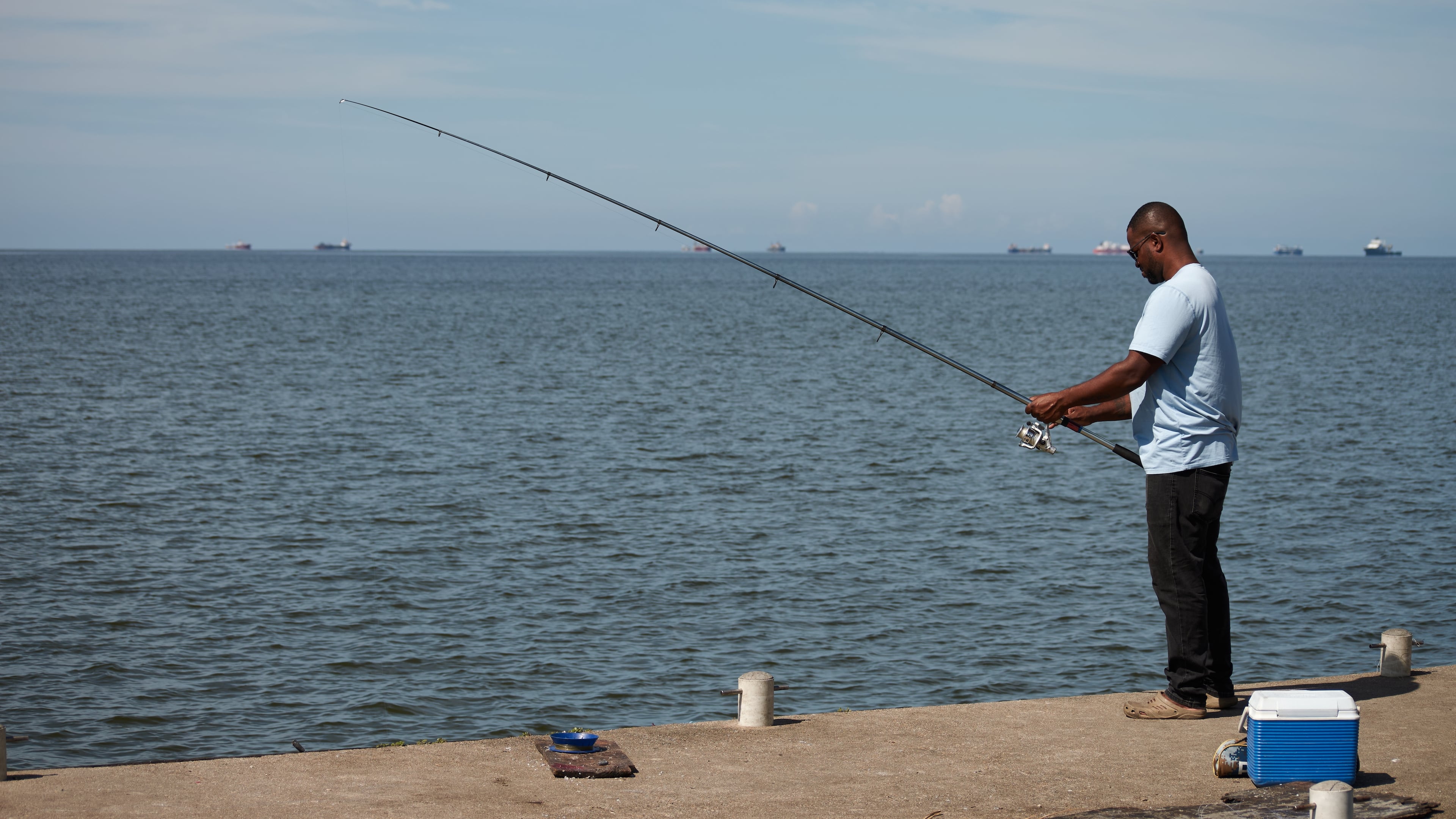 A man fishes in Cocorite, Trinidad and Tobago, Friday, Oct. 3, 2025. (AP Photo/Anselm Gibbs)
