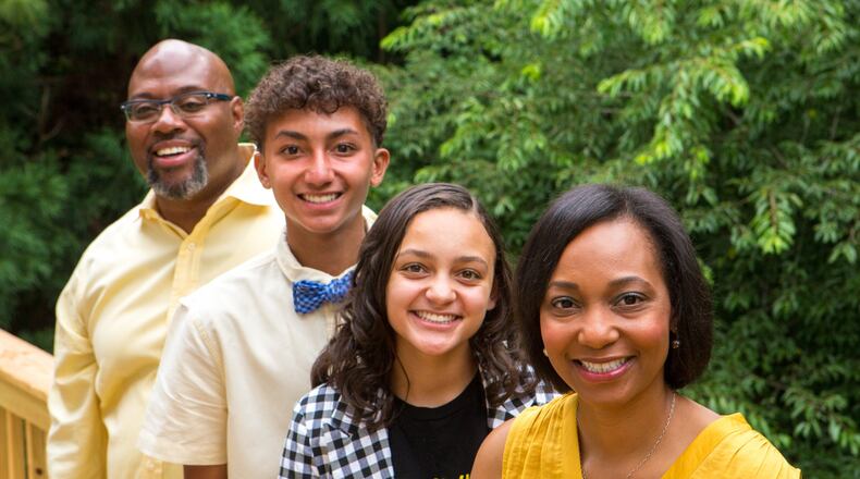 (From right to left) Sheila “Michelle” Foye, along with her daughter Mia, her son Miles, and her husband Keith, pose together for a portrait at their home in Lithonia, Ga., on Wednesday, June 12, 2019. Three years ago, on June 15, 2016, Foye’s 24-year-old son, DJ Dicks Jr., was murdered at a park in Columbus, Ga., after a drug deal. Now, Foye has organized a scholarship in his honor, but has recently had trouble finding enough applicants. Foye thought it was important to do something positive in DJ’s legacy and to provide a support base for kids that might otherwise be at risk of becoming involved with drugs or gangs. “Just because he was killed doesn’t mean his life was meaningless,” says Foye. (Casey Sykes for The Atlanta Journal-Constitution)