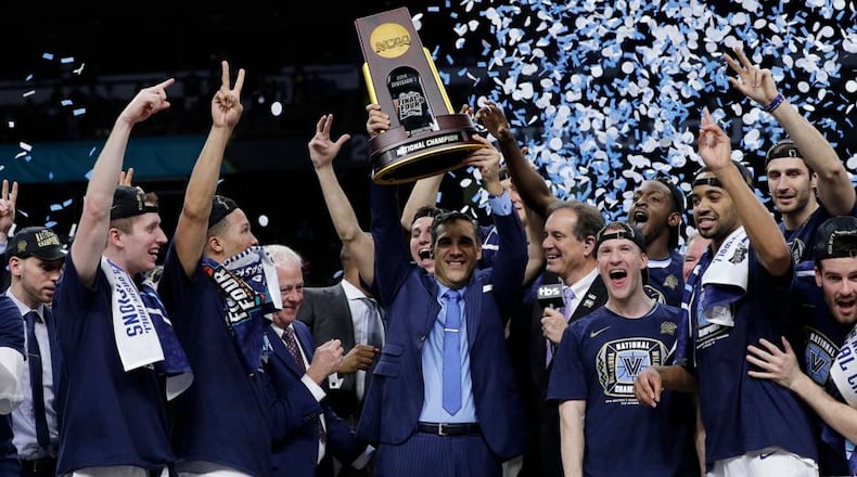 Villanova head coach Jay Wright, center, celebrates with his team after beating Michigan 79-62 in the championship game of the Final Four NCAA college basketball tournament, Monday, April 2, 2018, in San Antonio. (AP Photo/David J. Phillip)