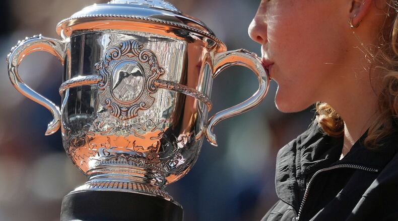 Russia's Mirra Andreeva poses with the trophy after winning the final women's tennis match against Poland's Maja Chwalinska at the French Open in Paris, Saturday, June 6, 2026. (AP Photo/Aurelien Morissard)