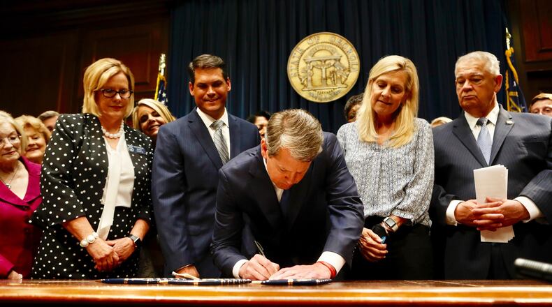 Gov. Brian Kemp signs legislation that outlaws most abortions at about six weeks, making it one of the toughest laws regulating the procedure. Opponents of the measure have vowed to sue the state over the law. Bob Andres/bandres@ajc.com
