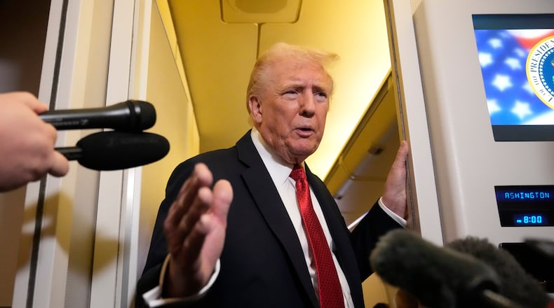 President Donald Trump speaks to reporters aboard Air Force One, Sunday, Oct. 19, 2025, en route to Joint Base Andrews, Md., as he returns from a trip to Florida. (AP Photo/Mark Schiefelbein)