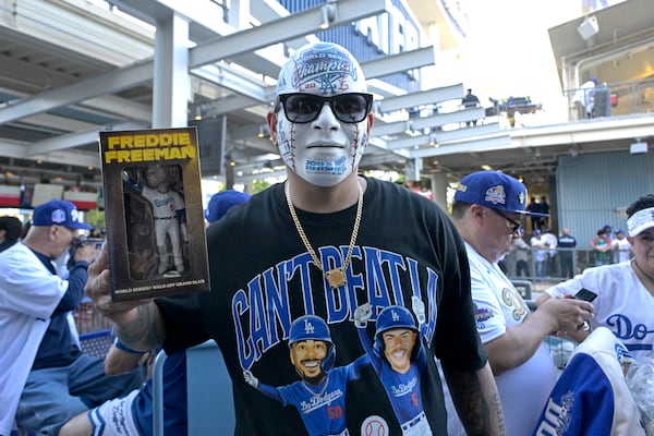 Los Angeles Dodgers fan Angel Rodriguez holds his Freddie Freeman bobblehead prior to a baseball game against the Chicago Cubs, Friday, April 11, 2025, in Los Angeles. (AP Photo/Jayne Kamin-Oncea)