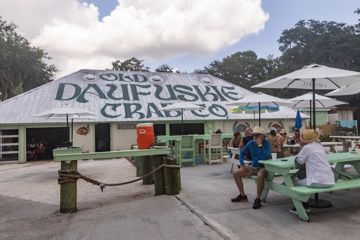Patrons at Old Daufuskie Crab Co. wait for their orders to arrive. This eatery in Daufuskie Island, South Carolina, is known for deviled crab and a cocktail called a Scrap Iron. (Katelyn Myrick for The Atlanta Journal-Constitution)