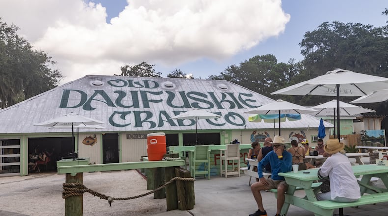 Patrons at Old Daufuskie Crab Co. wait for their orders to arrive. This eatery in Daufuskie Island, South Carolina, is known for deviled crab and a cocktail called a Scrap Iron. (Katelyn Myrick for The Atlanta Journal-Constitution)