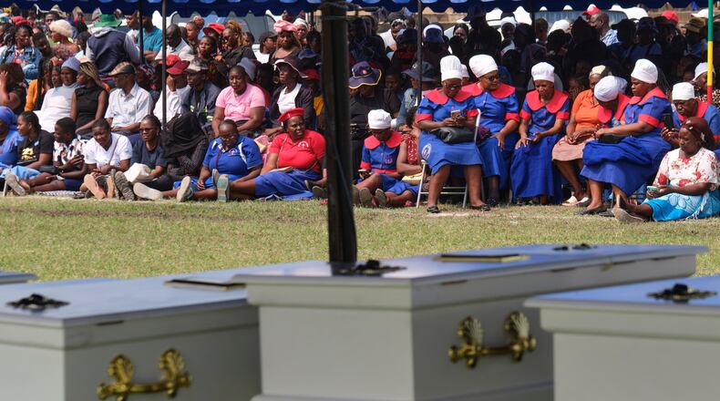 Mourners gather for a memorial service for the victims of a ferry capsized on lake Kariba in Kariba, Zimbabwe, Thursday, Aug. 13, 2026. (AP Photo/Mkhululi Thobela)