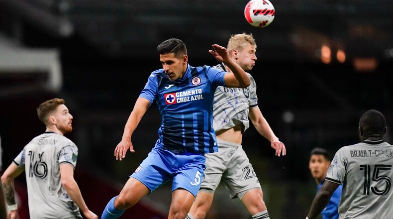 Luis Abram of Mexico's Cruz Azul, left, and Róbert Thorkelsson of Canada's CF Montreal fight for the ball during a CONCACAF Champions League quarterfinal soccer match in Mexico City, Wednesday, March 9, 2022. (AP Photo/Eduardo Verdugo)