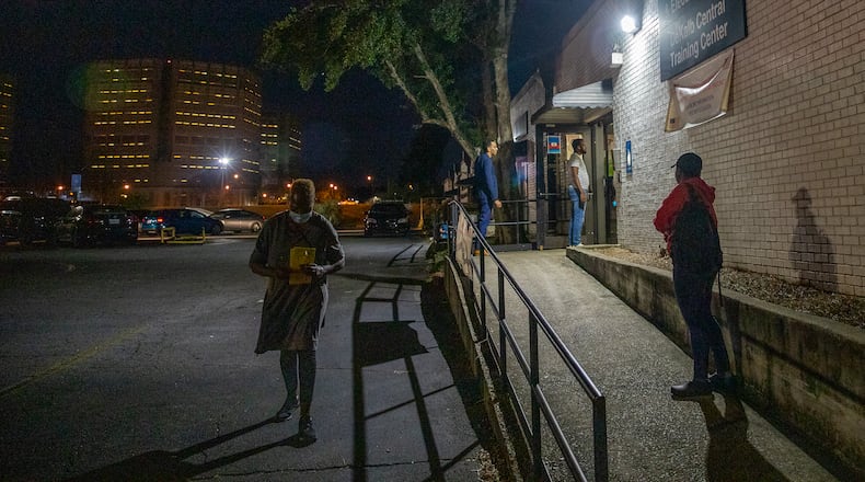 Before the poles close, DeKalb residents bring in their absentee ballots to the DeKalb County Elections Office on Tuesday, Nov 8, 2022. (Jenni Girtman for The Atlanta Journal-Constitution)