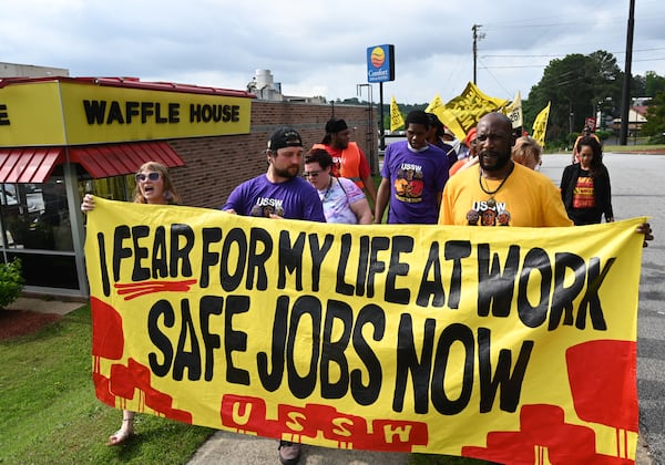 Waffle House employees and Union of Southern Service Workers organizers rally outside the Waffle House on Windy Hill Road in Marietta on Friday. The USSW, which represents low-wage workers in the service industry, has posted a petition with demands for Waffle House to raise employees’ base pay, end a mandatory deductions policy for worker meals and provide 24-hour security at restaurants. (Hyosub Shin/AJC)
