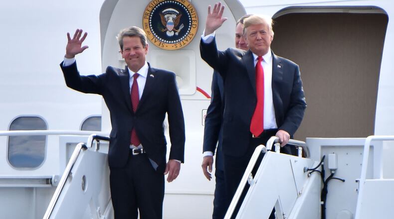 November 4, 2018 Macon - GOP gubernatorial candidate Brian Kemp and President Donald Trump wave from Air Force One as President Donald J. Trump arrives during President Donald J. Trump's Make America Great Again Rally to support Brian Kemp at Middle Georgia Regional Airport in MaconSunday, November 4, 2018. HYOSUB SHIN / HSHIN@AJC.COM