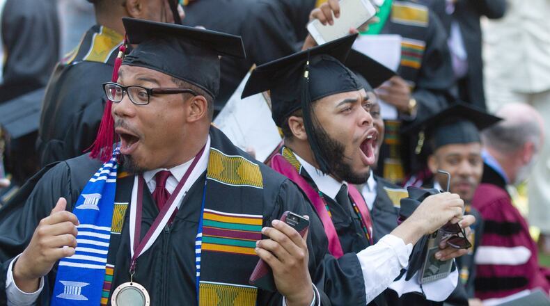 Graduates react after hearing billionaire Robert F. Smith is paying all student debt for the Class of 2019 during the Morehouse College graduation ceremony in Atlanta on Sunday, May 19, 2019. STEVE SCHAEFER / SPECIAL TO THE AJC