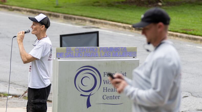 A protester uses a loudspeaker while trying to discourage women from getting abortions at the Feminist Women's Health Center in Atlanta. (AJC 2022)