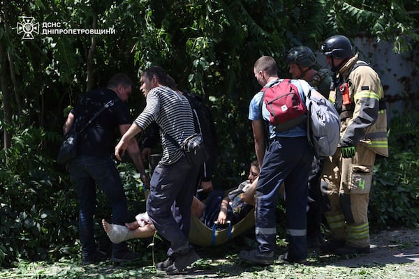 In this photo provided by the Ukrainian Emergency Service, rescuers carry an injured civilian following Russia's missile attack in Dnipro, Ukraine, Tuesday, June 24, 2025. (Ukrainian Emergency Service via AP)