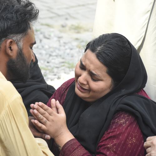 Parents react after their child died in a hospital fire in Islamabad, Pakistan, Wednesday, Aug. 26, 2026. (AP Photo/