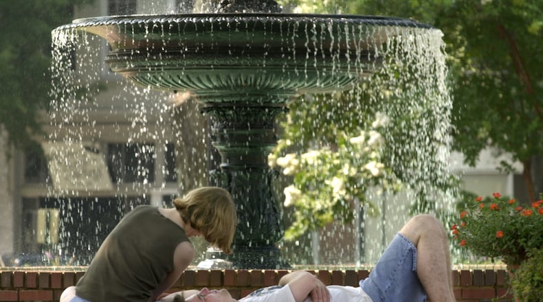 July 3, 2000: Valerie Stockett and Matt Riedel both from Baltimore, Maryland, enjoying a restful morning interlude near the popular fountain on the Marietta Square. They were in town for the holiday visiting Stockett's parents.