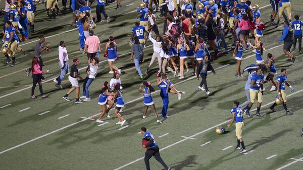 McEachern fans and players storm the field after Friday's win over Hillgrove. (Daniel Varnado/Special)