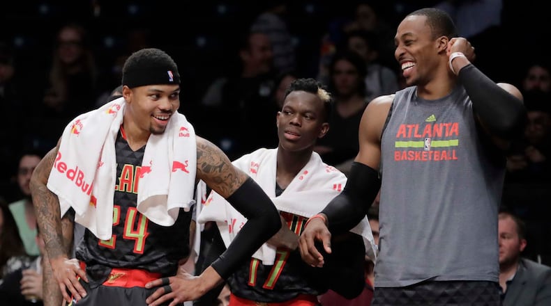Atlanta Hawks’ Kent Bazemore, left; Dennis Schroder, center, and Dwight Howard, right, smile during the second half of the team’s NBA basketball game against the Brooklyn Nets on Tuesday, Jan. 10, 2017, in New York. The Hawks won 117-97. (AP Photo/Frank Franklin II)