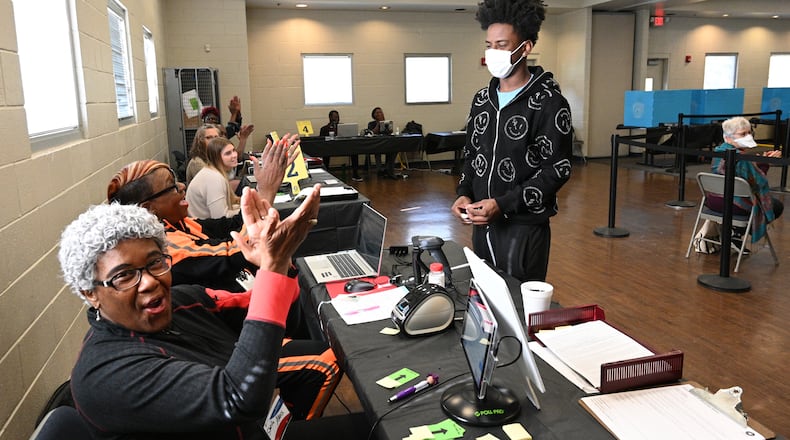 First-time voter Channing Settles, 18, is recognized by poll workers Saturday at an early voting location in the Mountain Park Activity Building in Stone Mountain. (Hyosub Shin / Hyosub.Shin@ajc.com)