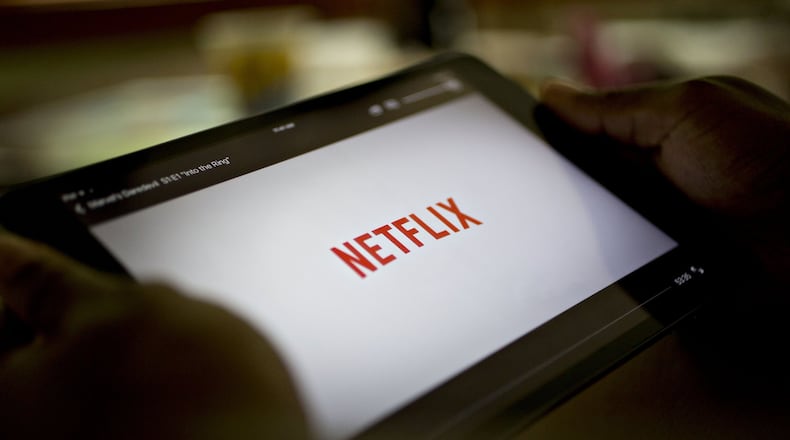 The Netflix app is displayed for a photograph on an Apple iPad. Georgia legislators are considering whether to impose a 4 percent tax on streaming video, downloaded media and other communication services. Bloomberg photo by Daniel Acker