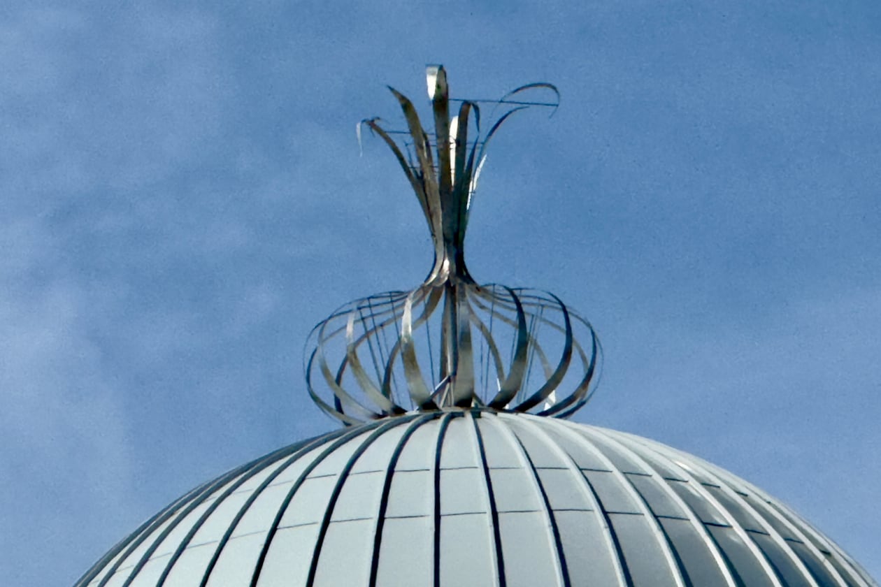 A metalwork onion adorns the top of the Toombs County Government Center in Lyons. The ornament is a nod to the renowned Vidalia onions that grow in this region of eastern Georgia. (Joe Kovac Jr./AJC)