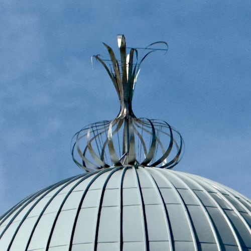 A metalwork onion adorns the top of the Toombs County Government Center in Lyons. The ornament is a nod to the renowned Vidalia onions that grow in this region of eastern Georgia. (Joe Kovac Jr./AJC)