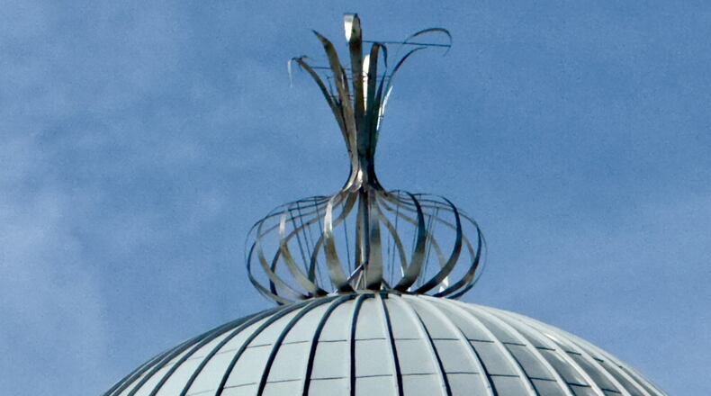 A metalwork onion adorns the top of the Toombs County Government Center in Lyons. The ornament is a nod to the renowned Vidalia onions that grow in this region of eastern Georgia. (Joe Kovac Jr./AJC)