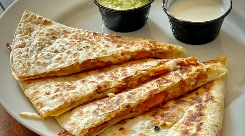El Burro Pollo's kimchi quesadilla uses house-made kimchi to brighten up an already wonderful cheese quesadilla. Henri Hollis/henri.hollis@ajc.com