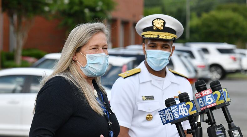 July 2, 2020 Lawrenceville - Gwinnett Newton Rockdale Health Director Audrey Arona speaks as U.S. Surgeon General Jerome Adams (right) looks during a press conference amid a rise in coronavirus cases in Gwinnett County outside the Louise Radloff Administrative Building in Lawrenceville on Thursday, July 2, 2020. (Hyosub Shin / Hyosub.Shin@ajc.com)