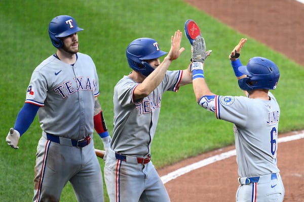 Texas Rangers' Josh Jung (6) celebrates his two-home run with Evan Carter, center, and Jonah Heim, left, during the fourth inning of a baseball game against the Baltimore Orioles, Wednesday, June 25, 2025, in Baltimore. (AP Photo/Nick Wass)