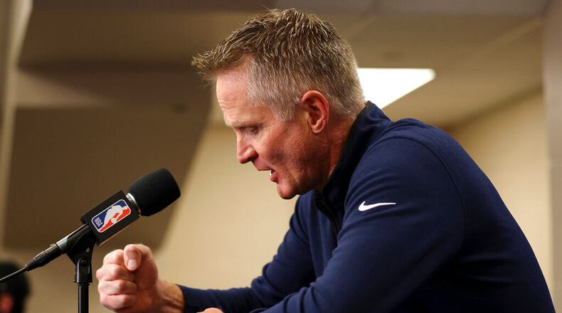 Reacting to the Uvalde, Texas, school shooting earlier in the day, Golden State Warriors coach Steve Kerr bangs his fist on the table as he makes a statement before Warriors played the Dallas Mavericks in Game 4 of the NBA basketball playoffs Western Conference finals Tuesday, May 24, 2022, in Dallas. (Scott Strazzante/San Francisco Chronicle via AP)